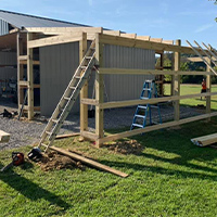 Additional garage space added to side of existing pole barn framing in progress